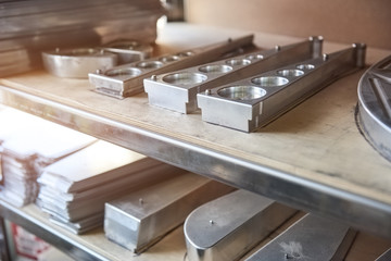 Stainless steel parts on shelf. Gray metal parts.