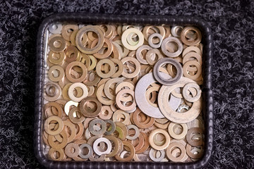 Steel washers on a plate. Various types of washers.