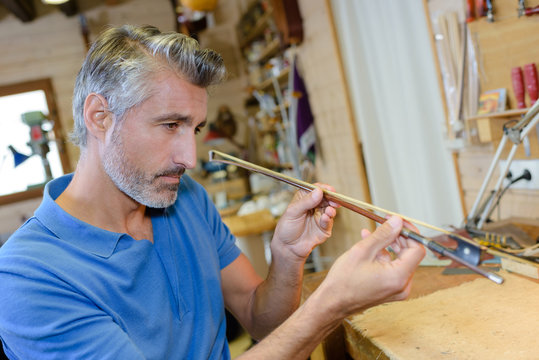 Instrument Maker In Workshop