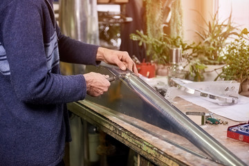 Man is installing a fastener. Man is installing a fastener in metal sheets.