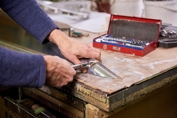 Fastener screwing. Worker is screwing a fastener using hand screwdriver.