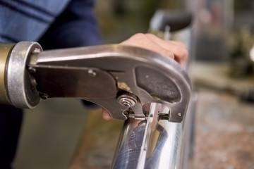 Rivet squeezer in action. Hand rivet squeezer close-up.