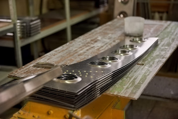 Aircraft parts on workshop desk. Steel panels, airplane fuselage.