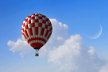 Aerostat floating in day sky. Mixed media