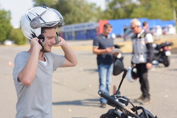 Fototapeta na wymiar young man learning how to ride a motorbike