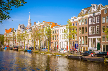 Traditional old buildings and and boats in Amsterdam, Netherlands. Canals of Amsterdam.