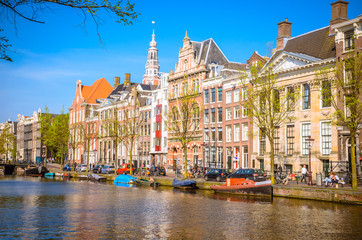 Traditional old buildings and and boats in Amsterdam, Netherlands. Canals of Amsterdam.