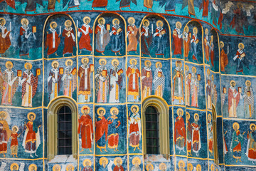 Orthodox church exterior with painted murals, painted church in Romania
