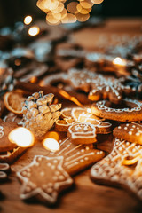 Freshly baked and homemade gingerbread cookies and food decorations on wooden table, flat lay view from above. Christmas handmade bakery. Family festive culinary and New Year traditions concept.