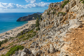 Stony landscape and a view of the Tsambika beach on the Rhodes Island, Greece