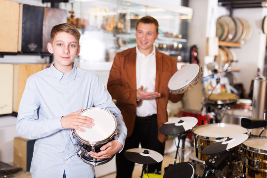 Boy and father choosing best drum
