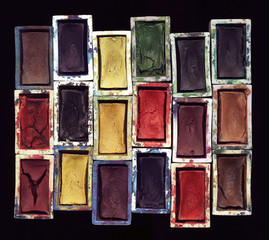 Set of old used watercolor paints close-up artistic background. One of art tools – color palette...
