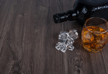 whisky on the rock on wood and wood background
