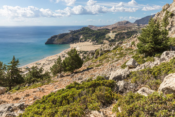 Fototapeta premium Stony landscape and a view of the Tsambika beach on the Rhodes Island, Greece
