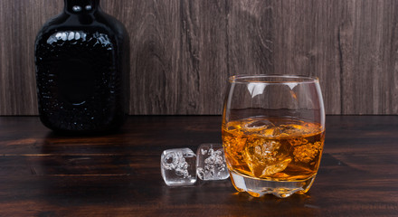 whisky on the rock on wood and wood background