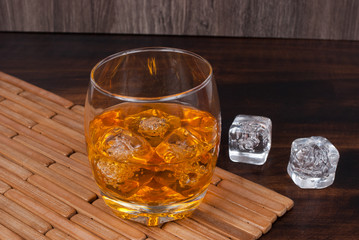 whisky on the rock on wood and wood background
