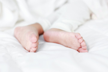 little baby feet on bed