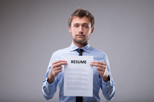 Potential male job applicant holding up his CV