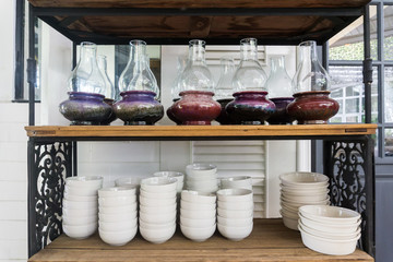 Fototapeta na wymiar Lantern and white bowl on shelf in restaurant