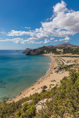 Fototapeta na wymiar Stony landscape and a view of the Tsambika beach on the Rhodes Island, Greece