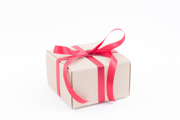 Brown gift box with red ribbon on white background