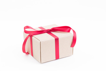 Brown gift box with red ribbon on white background