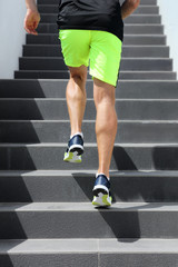 Fototapeta na wymiar Runner man athlete running up the stairs on hiit high intensity interval training city run. Jogging jogger climbing staircase sprinting with speed. Urban active lifestyle. Closeup of legs and shoes.