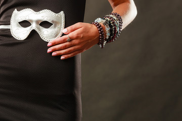 Woman with carnival venetian mask on dark