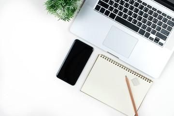 Business office work desk table with computer laptop , note and stationery on white table background include copyspace for add text or graphic