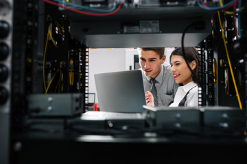 Team of technicians working together on servers at the data centre