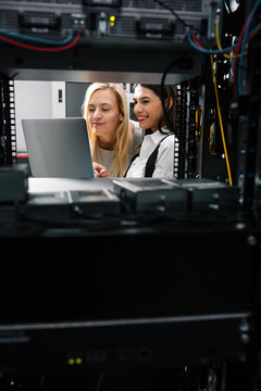 Team of technicians working together on servers at the data centre