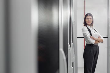 Technician using tablet pc while analysing server in large data center