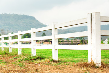 White concrete fence in farm field