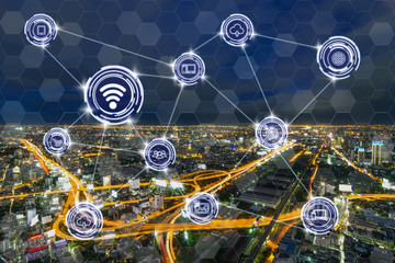 Wireless communication connecting of smart city Internet of Things Technology over the Expressways with bangkok cityscape at twilight time background, technology business IOT concept