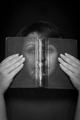 A woman looks through a book