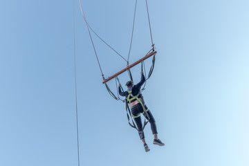man swinging on a machine for fun at Masukiye