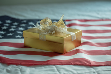 Gold gift box on american flag