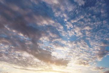Sunset or Sunrise with many tiny cloud.  light rays and other atmospheric effect. beautiful nature abstract background. sky before night. evening or morning moment. filtered image