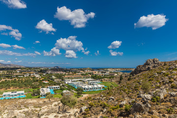 Obraz premium Stony landscape of Tsambika mountain and a view of Kolymbia, a small resort on the Rhodes Island, Greece.