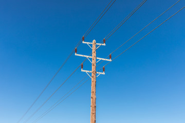 Obraz premium power lines on blue sky background