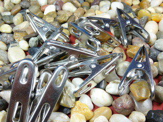 steel pegs on river stone  background close up
