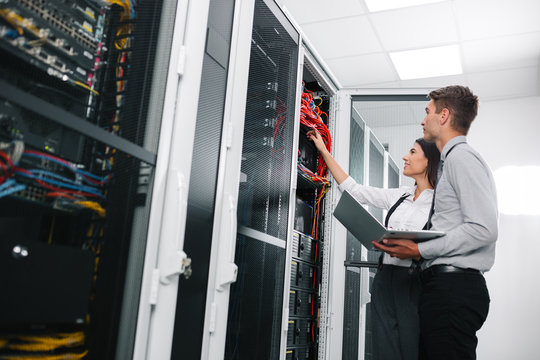 Team of technicians working together on servers at the data centre