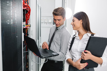 Team of technicians working together on servers at the data centre