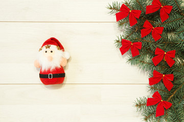 New Year / Christmas tree with red bows, Santa toy on the wooden background template