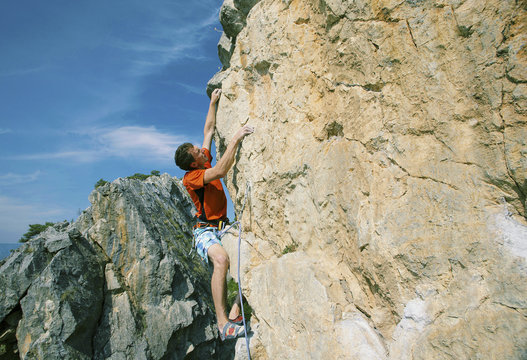 Rock climbing. A man climbs the rock.