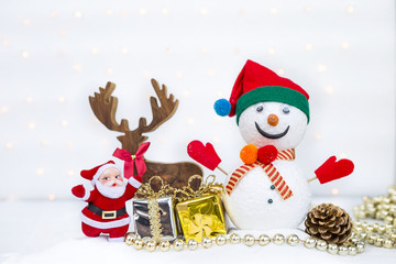 Christmas concept background of snowman with happy Santa Claus and gift box with christmas decoration over blurred bokeh on white background