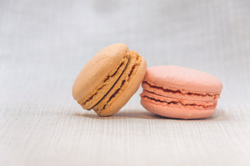 Delicious cake macaroons on light background, close up