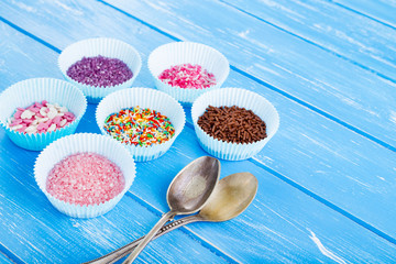 Colorful candy sprinkles on the paper cupcake holder