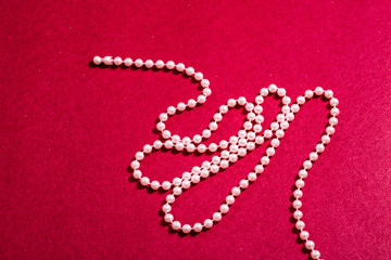 Pink Beads on Red Background
