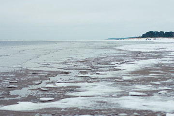 walk along the white sea shore in winter
